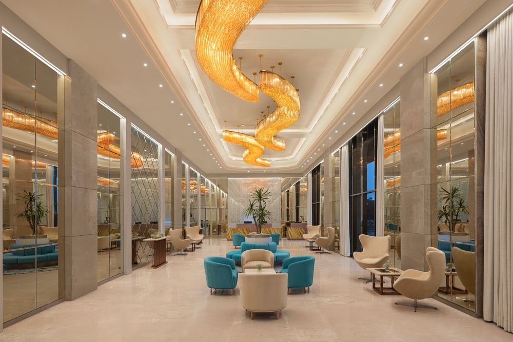 Double-height lobby under a sculptural gold ceiling