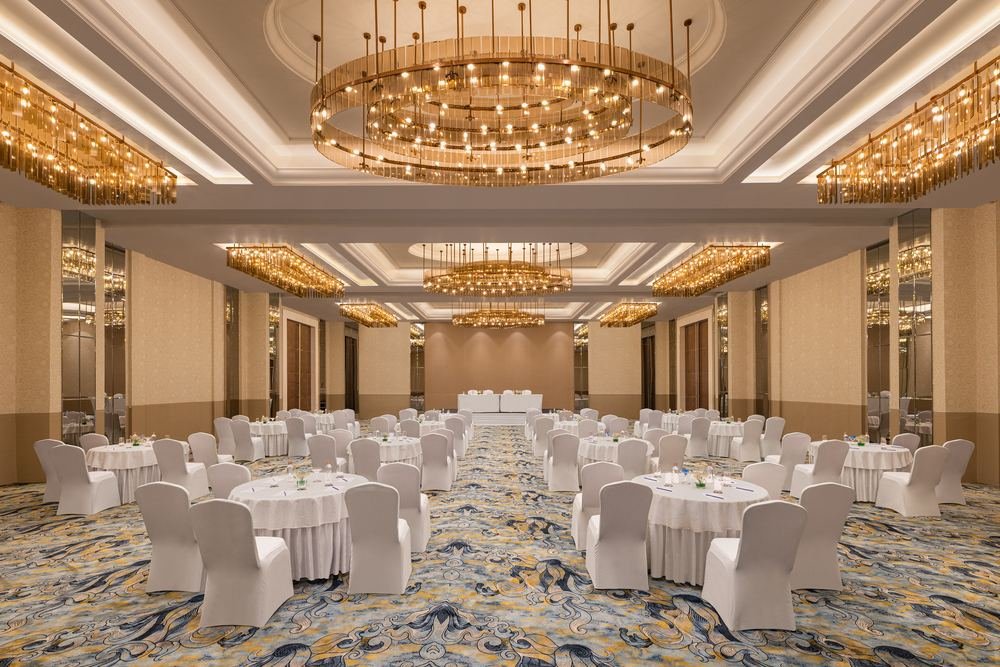 Grand banquet hall under layered chandeliers