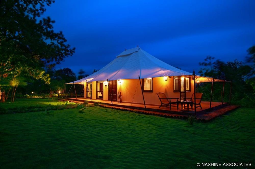 Tent lit against the blue hour