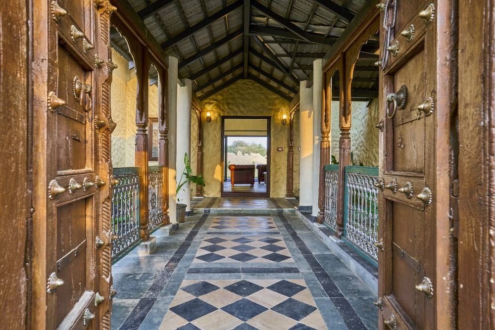 Carved doors opening onto the chequered stone gallery