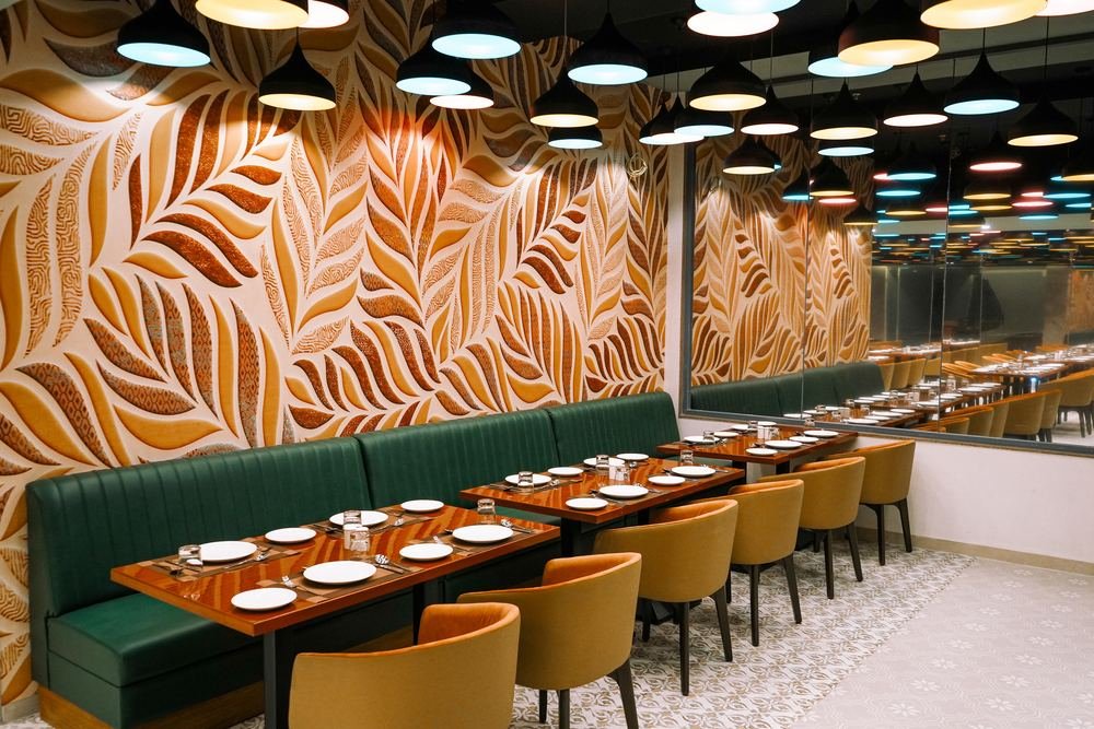Momentt Restaurant — oversized leaf-motif wall panels
